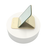 Small portable foldable mirror, lightweight, durable, and ideal for travel, touch-ups, and on-the-go beauty routines. Available in pink and cream color.